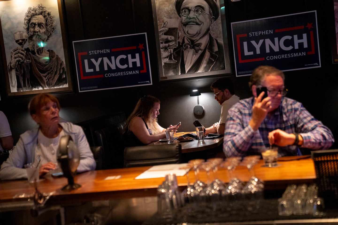 People wait patiently for election results at Representative Stephen F. Lynch’s election night watch party in Boston.