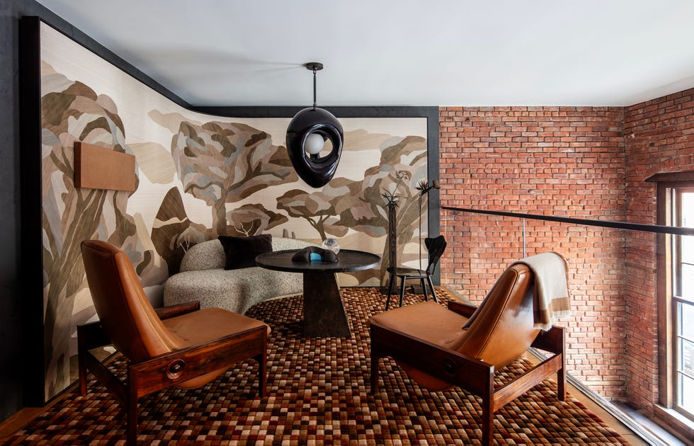 Modern living space featuring earthy tones, textured walls, unique furniture, and artistic elements.