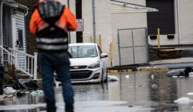 A worker assess flooding damage in Collingdale after a 2023 storm. Delaware County is installing flood gauges to help gather data and better prepare for increasingly intense precipitation events.