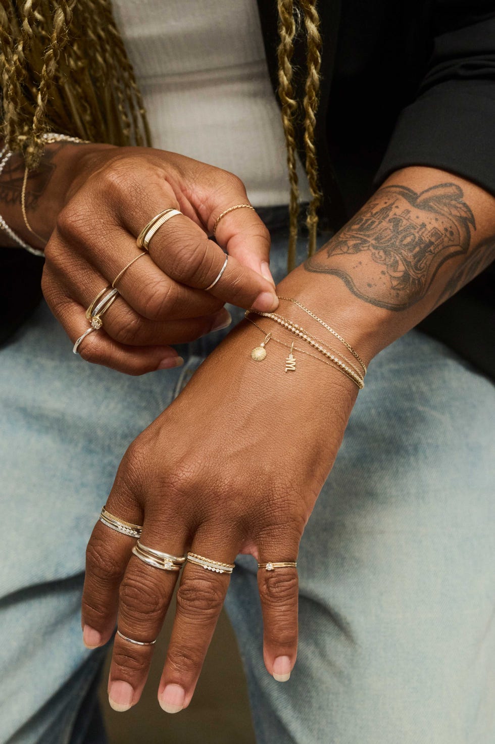 Close-up of intricately adorned hands with multiple rings and bracelets, showcasing unique jewelry styles. Close-up of intricately adorned hands with multiple rings and bracelets, showcasing unique jewelry styles.