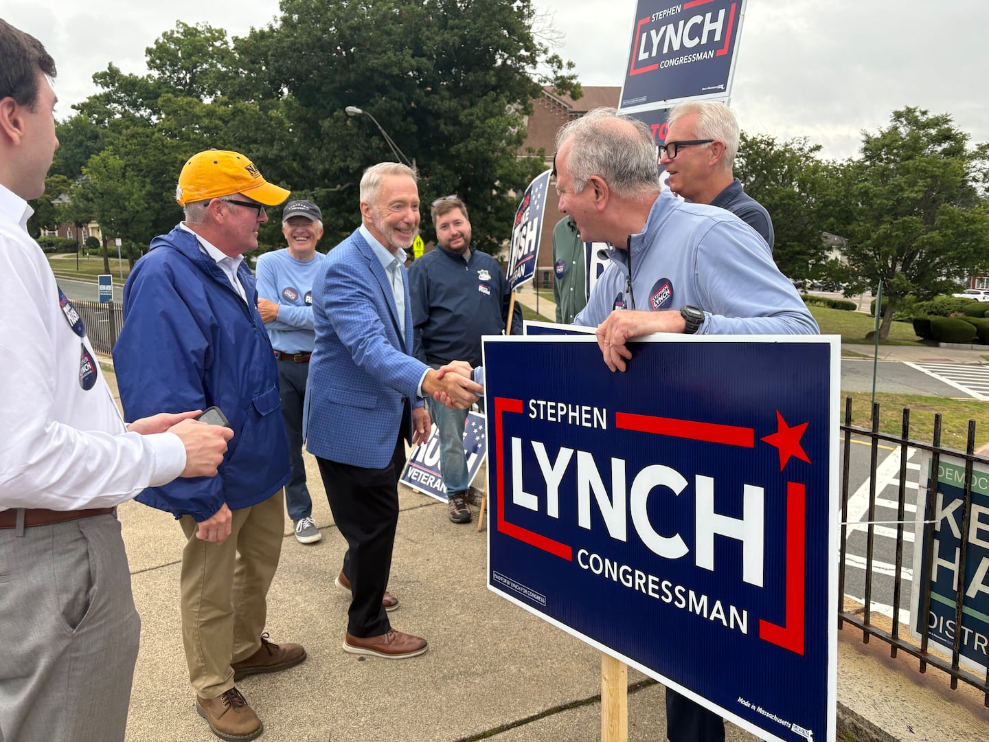 Representative Stephen Lynch of South Boston and State Senator Mike Rush greet volunteers at a polling place at Holy Name Parish School in West Roxbury on Election Day. 