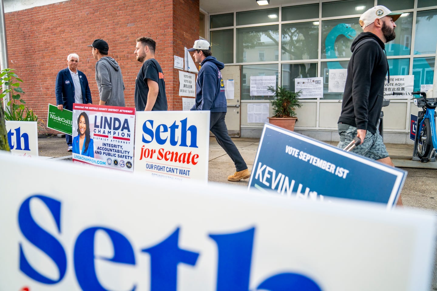 People walk past the polling station at South Boston Branch of the Boston Public Library on Election Day.