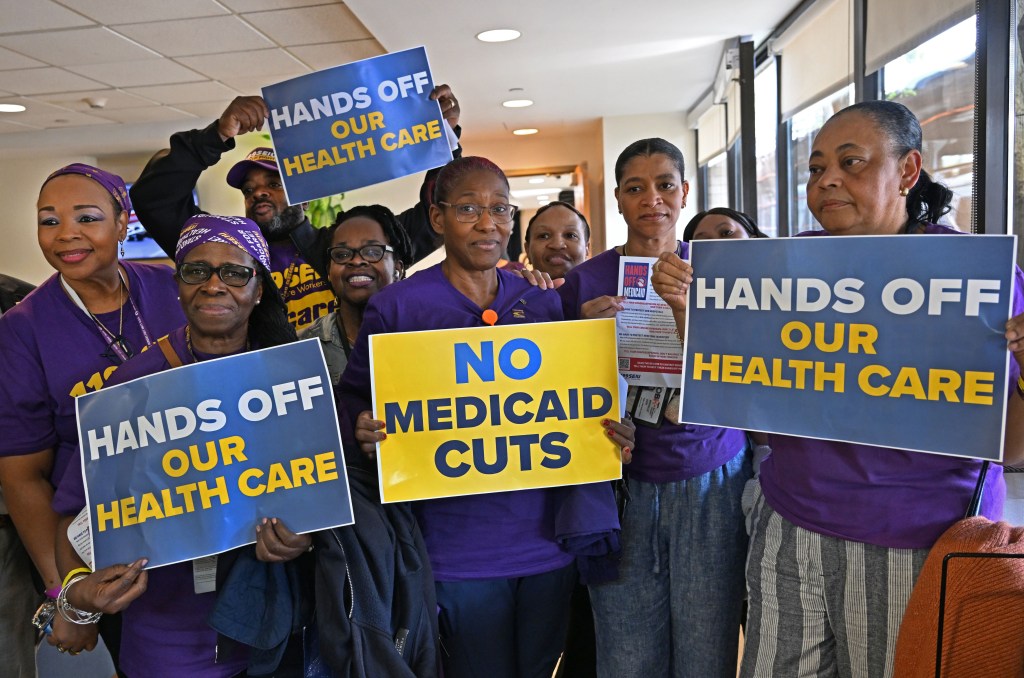 Members of the 1199 S.E.I.U. Healthcare Workers Union hold signs opposing healthcare and Medicaid cuts.
