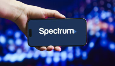 hand holding phone with Spectrum logo on screen