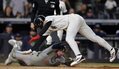New York Yankees' George Lombard Jr. avoids a tag from Tampa Bay Rays catcher Liam Hicks to score a run during the seventh inning of a baseball game Thursday, Sept. 24, 2026, in New York. (AP Photo/Adam Hunger)