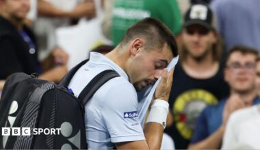 Arthur Gea wipes his face as he walks off court at the US Open