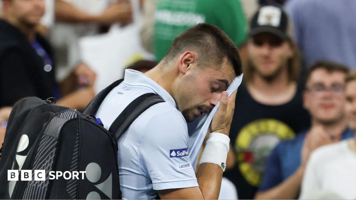 Arthur Gea wipes his face as he walks off court at the US Open