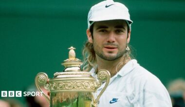 Andre Agassi celebrates with the trophy after winning Wimbledon in 1992