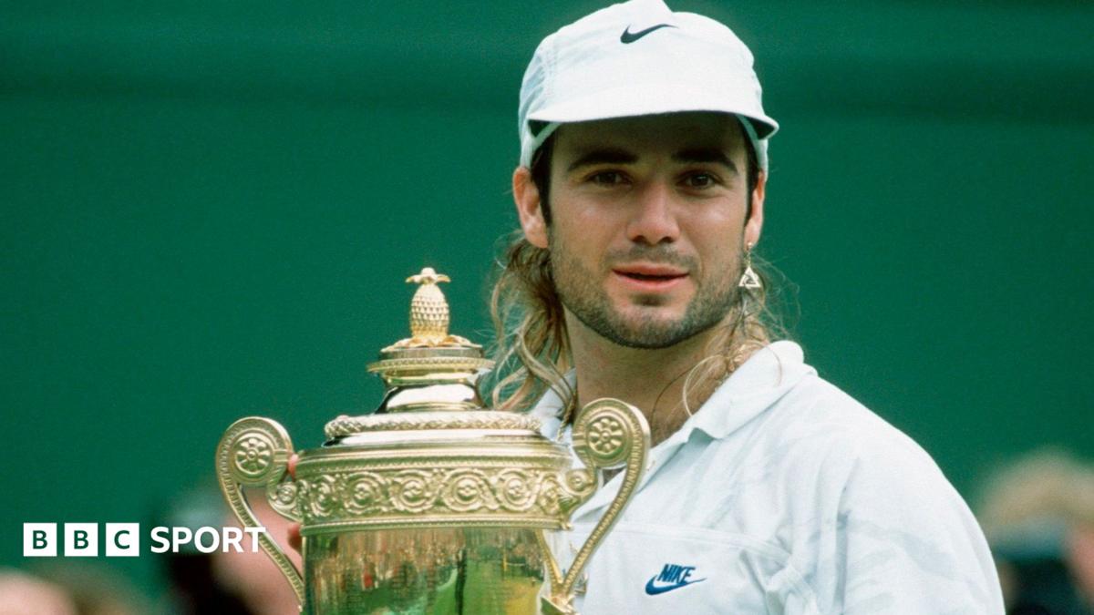 Andre Agassi celebrates with the trophy after winning Wimbledon in 1992