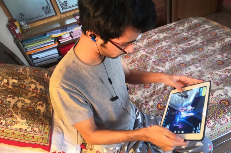 A youth plays an online game PUBG on his notebook in New Delhi, India
