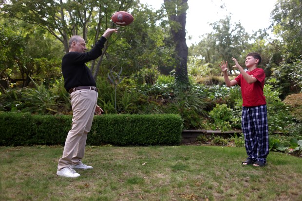 Greg Papa, left, throws a football with his son Skyler Shapiro, 11, on Monday, Aug. 17, 2026, in San Rafael, Calif. Aric Crabb/Bay Area News Group)