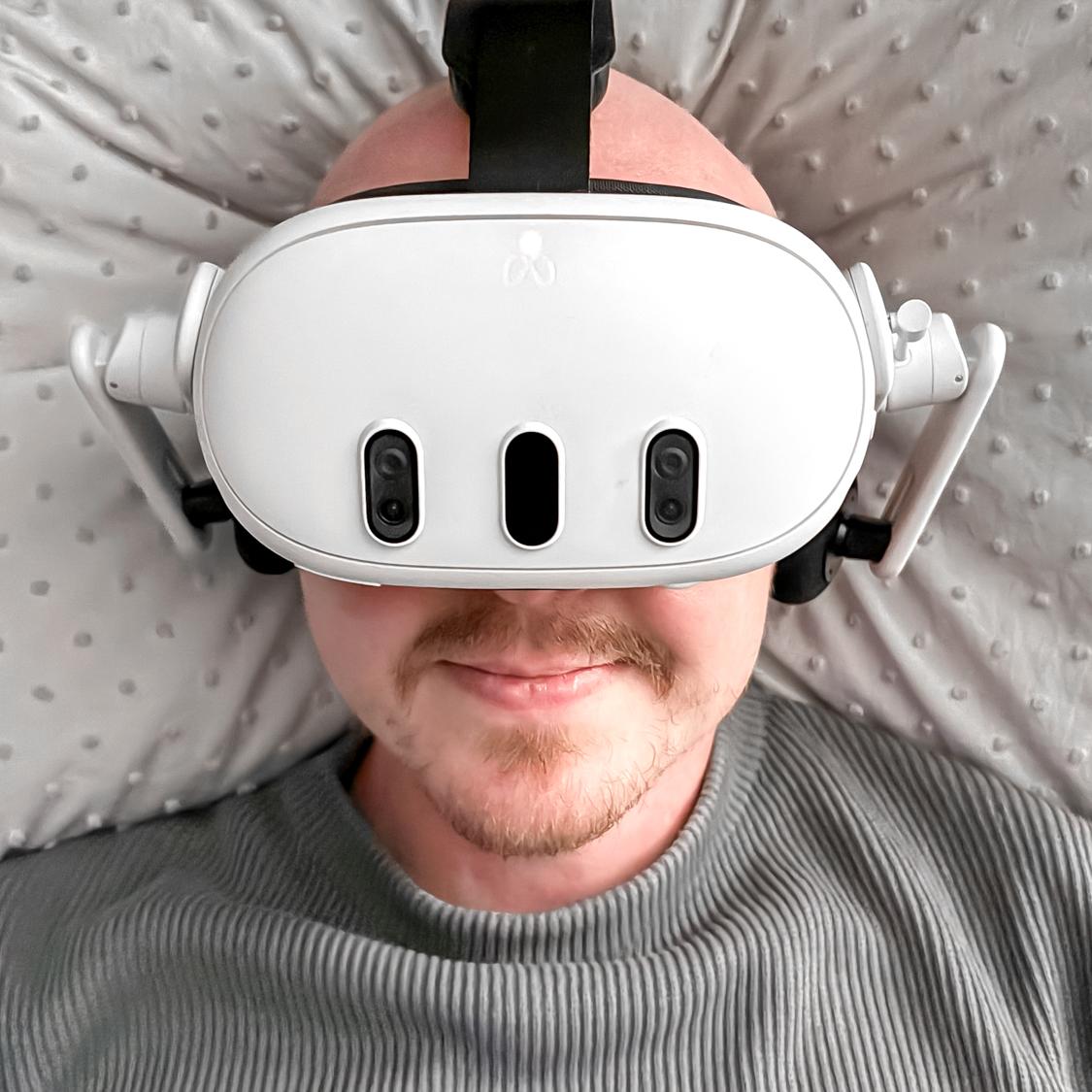 Person lying in bed wearing Meta Quest 3 with headstrap