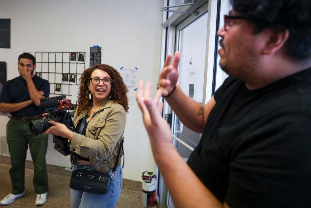 Jose Perez, right, gives instruction to fellow member Reeham Mourad while she tests a Blackmagic Pocket Cinema camera during a Camera 101 workshop at the Mouse Arts and Letters Club on Sept. 13, 2026. (Eileen T. Meslar/Chicago Tribune)