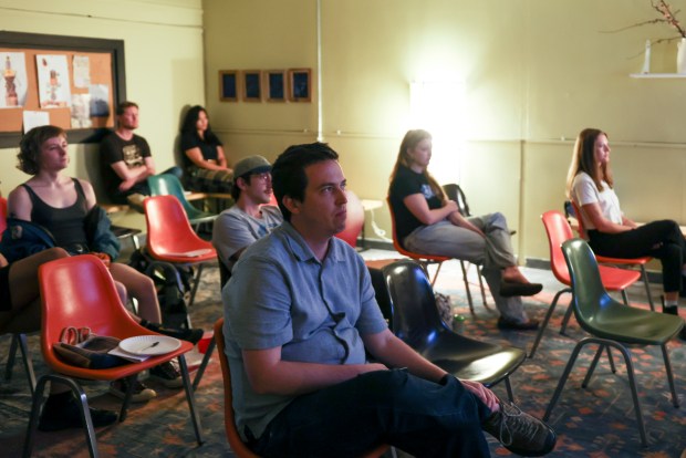 Co-founder Morley Musick, center, watches the non-narrative short film "Onomichi" by director Nobuhiko Ōbayashi during a Camera 101 workshop at the Mouse Arts and Letters Club, Sept. 13, 2026. (Eileen T. Meslar/Chicago Tribune)
