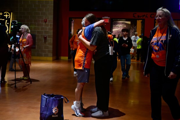 Fan Anne Rajotte, left, of West Hartford, embraces Connecticut Sun employee Delaney Roth, right, before the Sun's last WNBA basketball home game, Thursday, Sept. 24, 2026, at Mohegan Sun in Uncasville, Conn. The Sun are playing their final home game ever at Mohegan Sun in Connecticut before relocating to Houston.(AP Photo/Jessica Hill)
