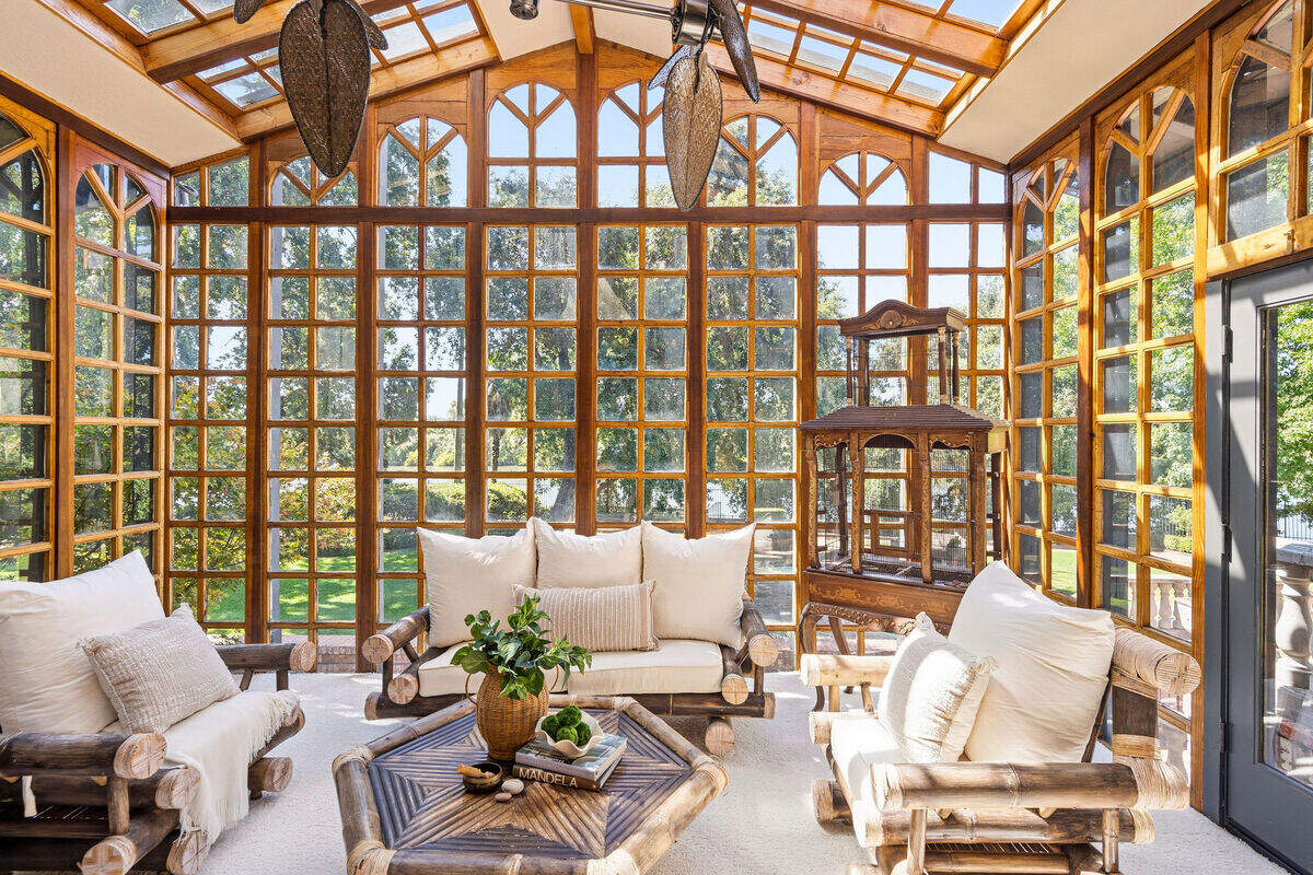 A wood-framed sun room off the primary bedroom overlooks the Sacramento River. The primary suite also includes multiple closets, a private laundry area and a spiral staircase leading to the fitness area below.