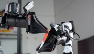 XDOF's robotic arms manipulate a pen and cap.