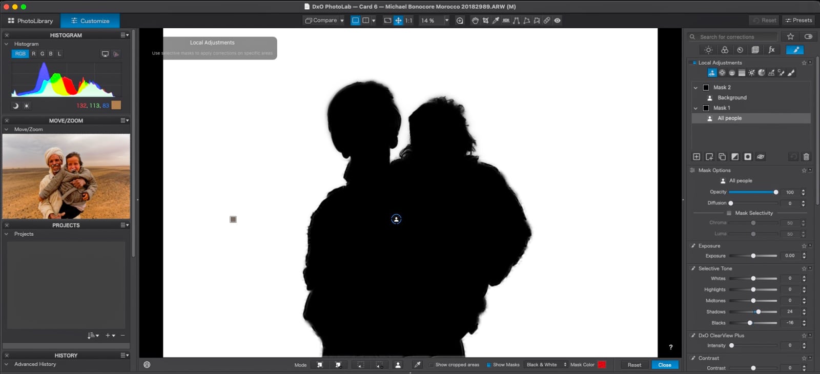 A screenshot of the DxO PhotoLab software interface showing a silhouette mask applied to two people, with the original image visible in the Move/Zoom panel.