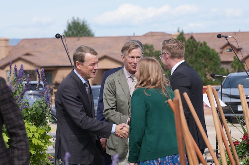 Elder Karl D. Hirst — a General Authority Seventy and member of the Church’s United States Central Area presidency, right — and his wife, Sister Claire Hirst, talk with U.S. Senators Michael Bennet, left, and John Hickenlooper, second from left, before the groundbreaking ceremony for the Colorado Springs Colorado Temple on Saturday, Sept. 12, 2026, in Colorado Springs, Colorado.