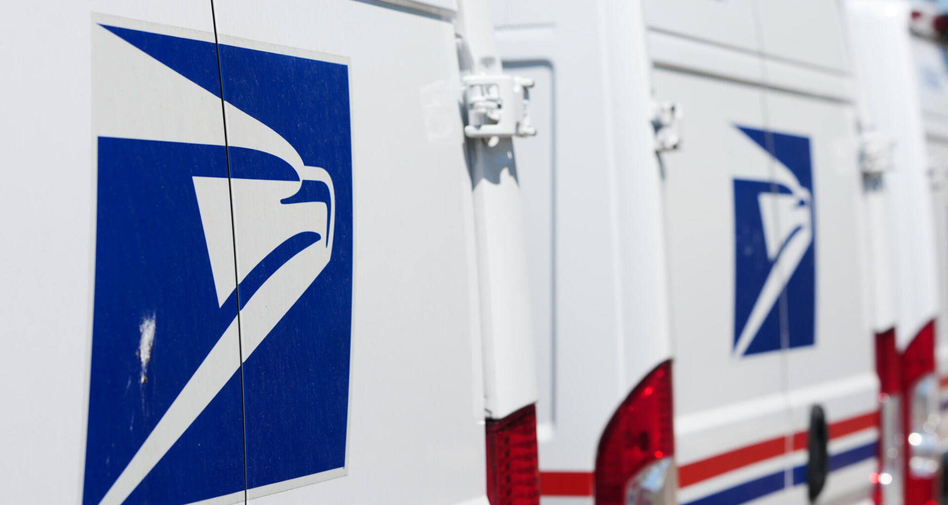 Delivery vans are parked outside the main United States Postal Service headquarters in northeast Denver. (David Zalubowski/AP, File)