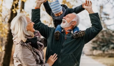 older couple walking in park with grandchild
