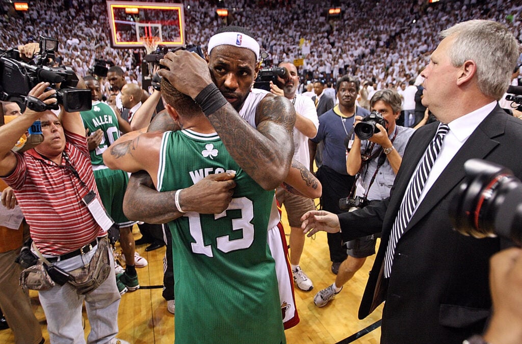 (051111 Miami, FL) Celtics Executive Director of Basketball Operations, Danny Ainge (R) looks over at Miami Heat small forward LeBron James as he gives Boston Celtics shooting guard Delonte West a hug after beating the Celtics 97-87 in the fourth qua