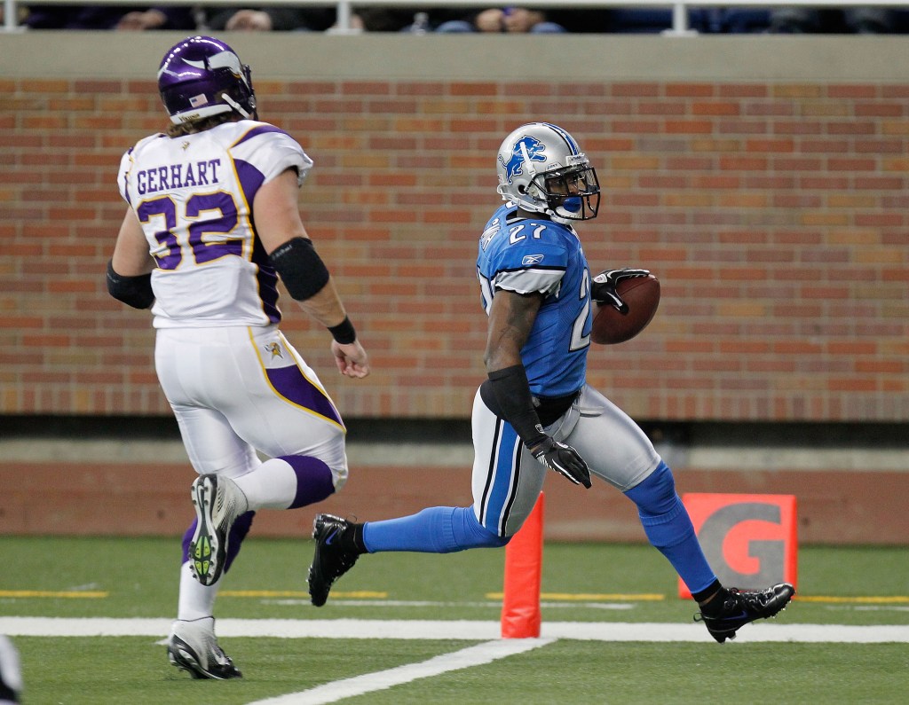 Alphonso Smith #27 of the Detroit Lions scores a touchdown after a second quarter interception in front of Toby Gerhart #32 of the Minnesota Vikings at Ford Field on December 11, 2011 in Detroit, Michigan.