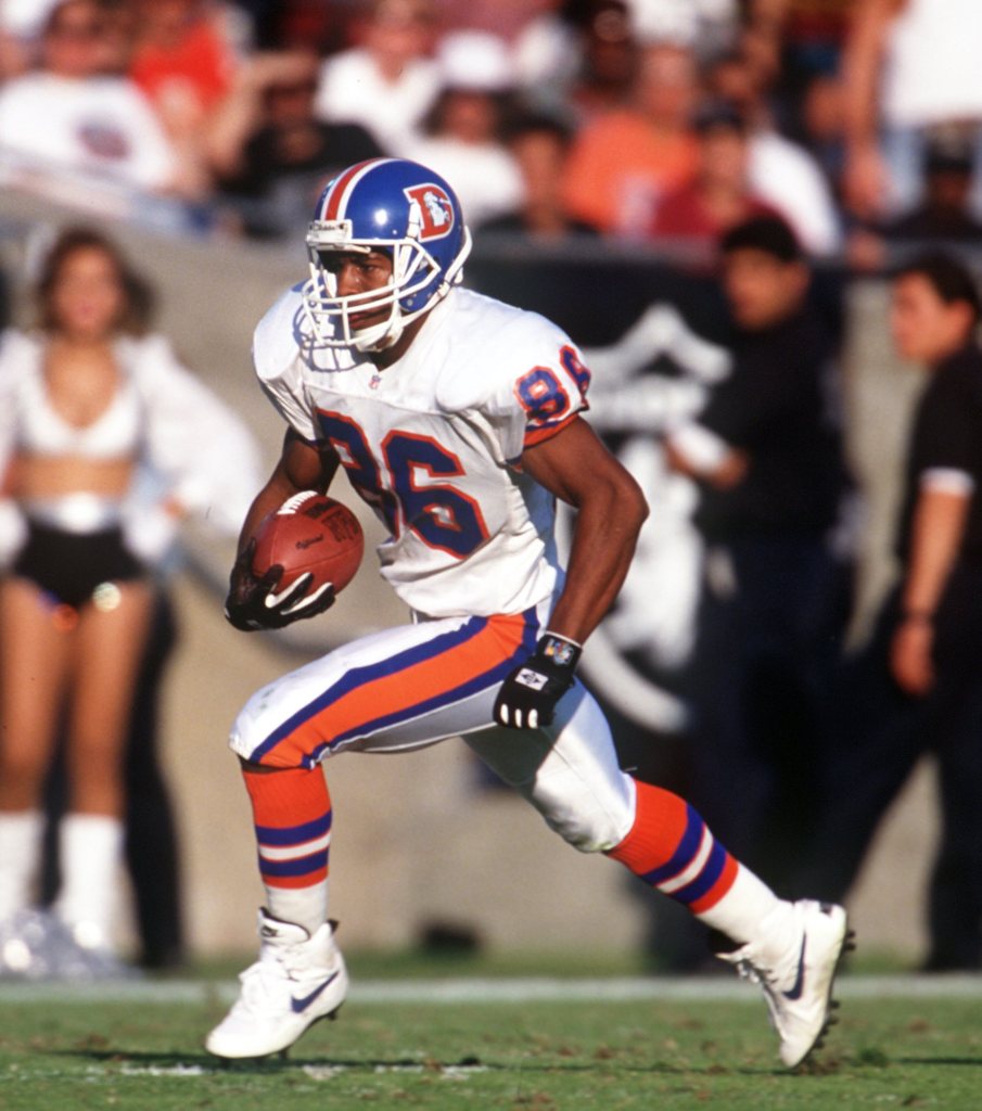 Arthur Marshall in a white Denver Broncos uniform running with a football.