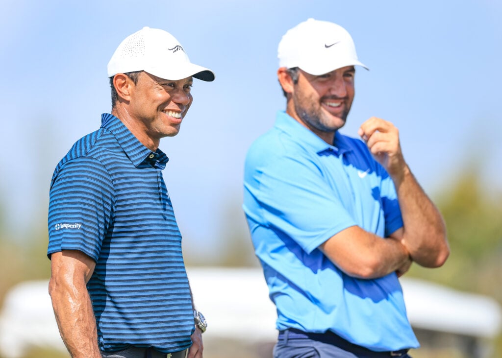 Tiger Woods of The United States out on the course watching Scottie Scheffler of The United States on the 16th hole during the pro-am prior to the Hero World Challenge 2025