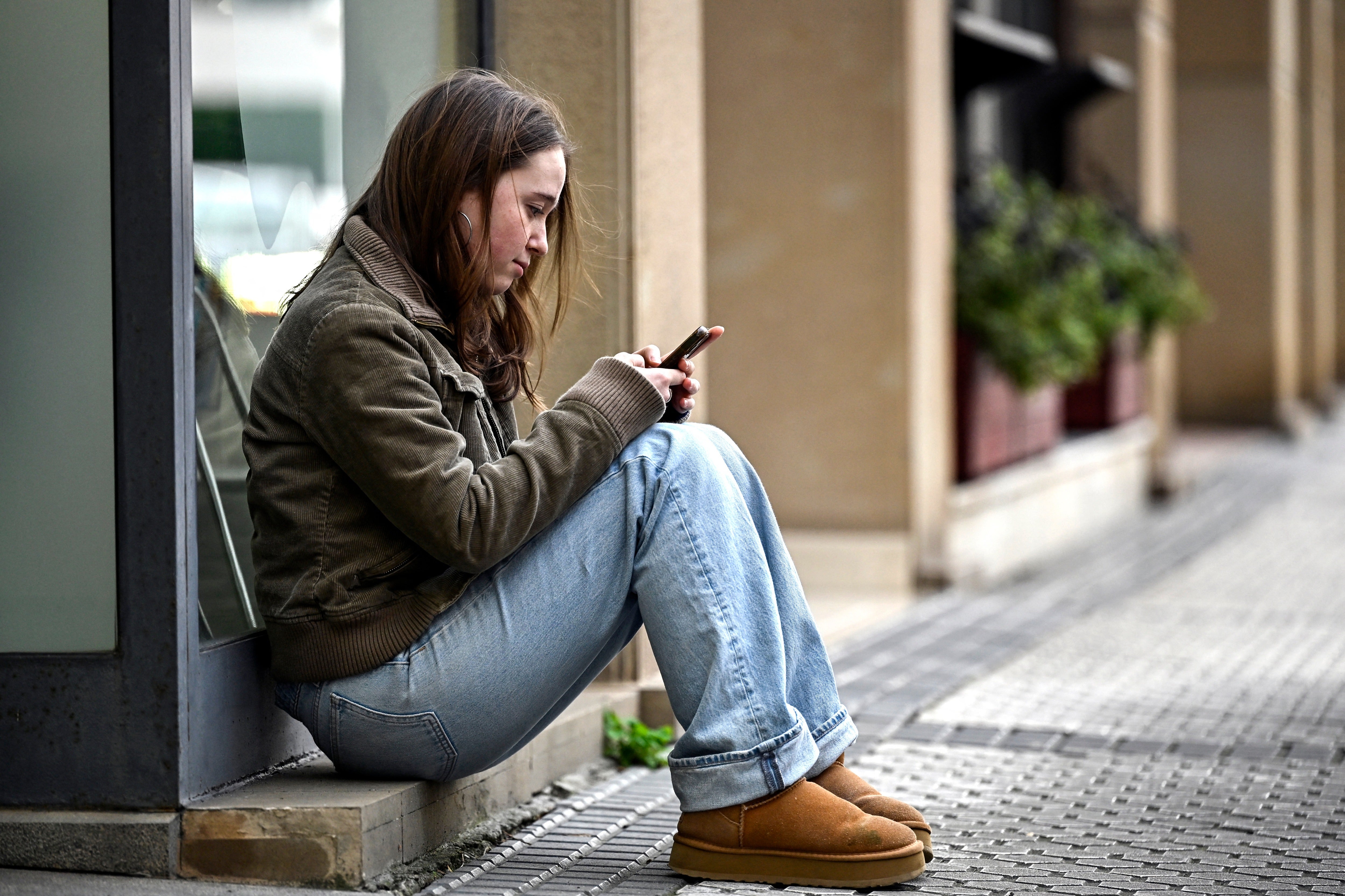 A girl uses her phone in the Spanish Basque city of San Sebastian in February. Experts stress that parents consider the health impacts of smartphones on their children