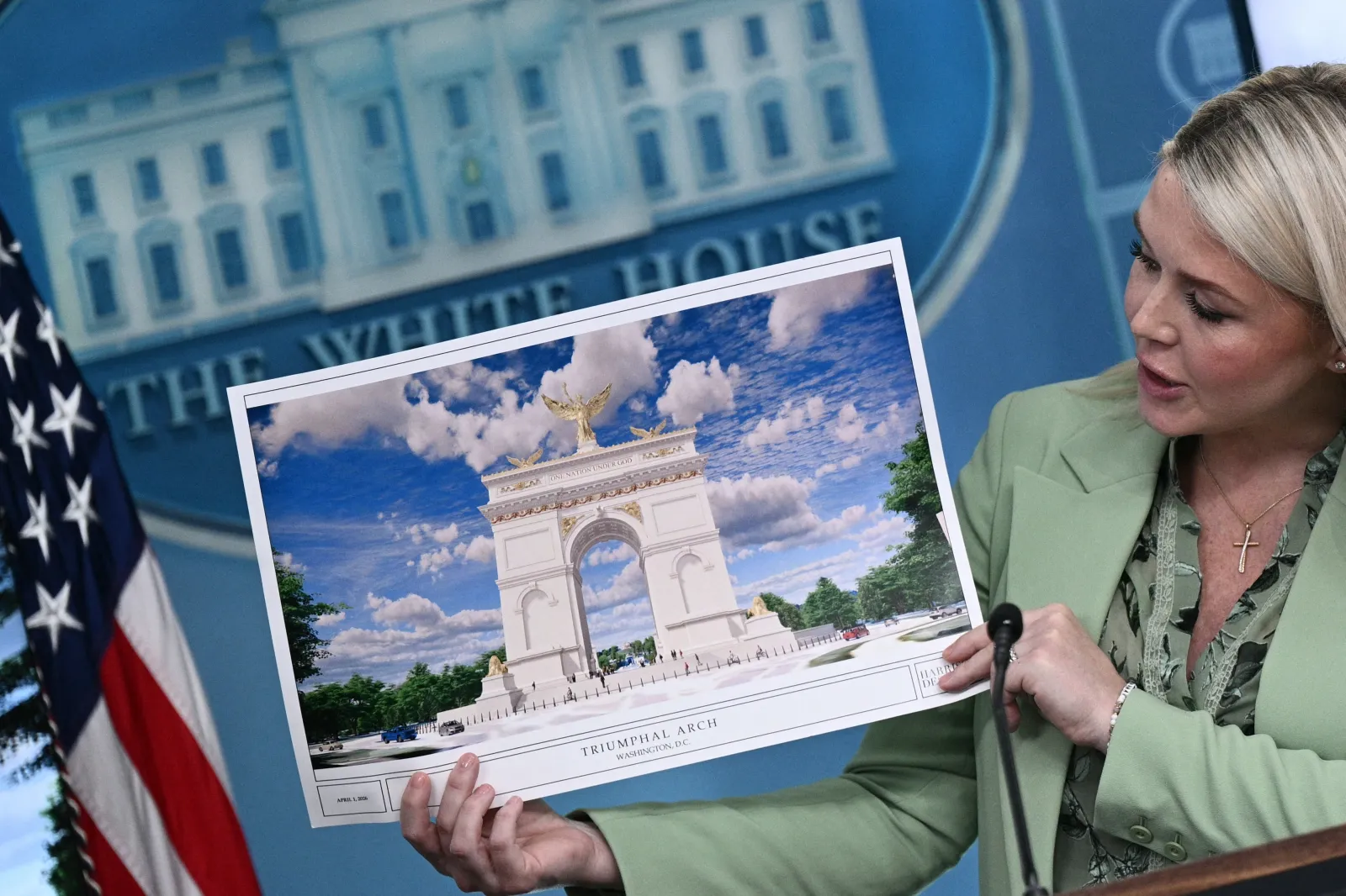 FILE - White House Press Secretary Karoline Leavitt shows an artist's rendering of President Donald Trump's planned Triumphal Arch during a press briefing in the Brady Briefing Room at the White House in Washington, D.C., on April 15, 2026.