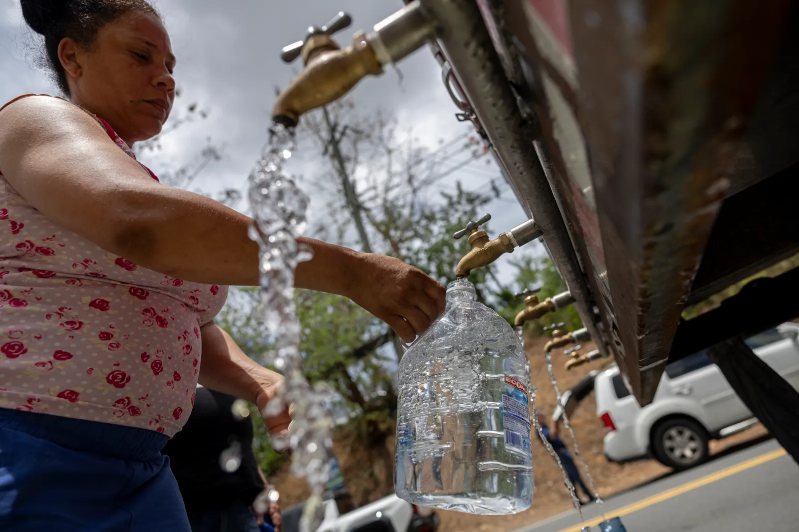 A resident collects water from a tanker truck at a distribution point during a government imposed water rationing amid a severe drought in San Juan, Puerto Rico, on August 6, 2026.
