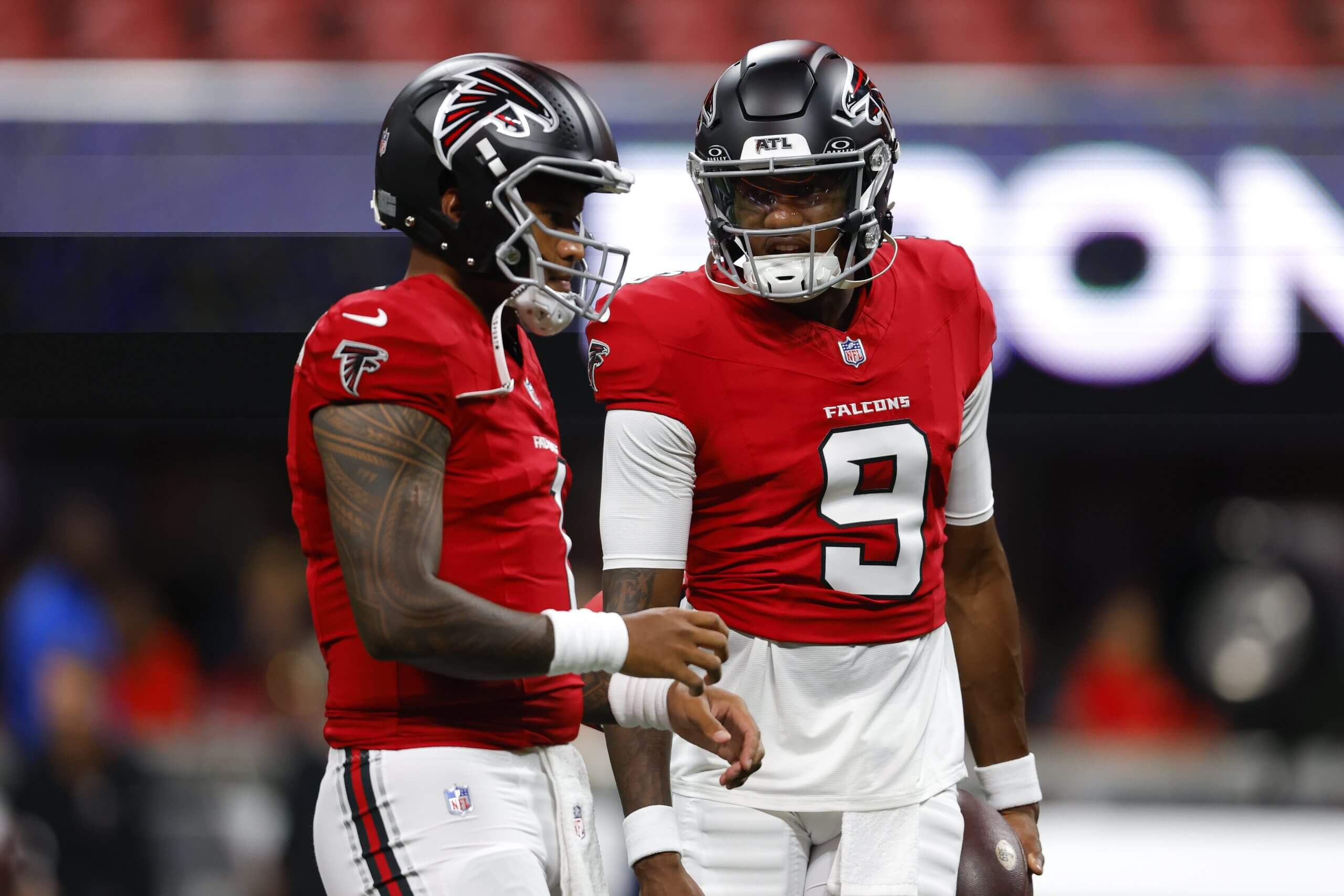 Tua Tagovailoa, left, of the Atlanta Falcons warms up with Michael Penix Jr. before the NFL preseason game against the Denver Broncos at Mercedes-Benz Stadium on Aug. 14, 2026, in Atlanta.