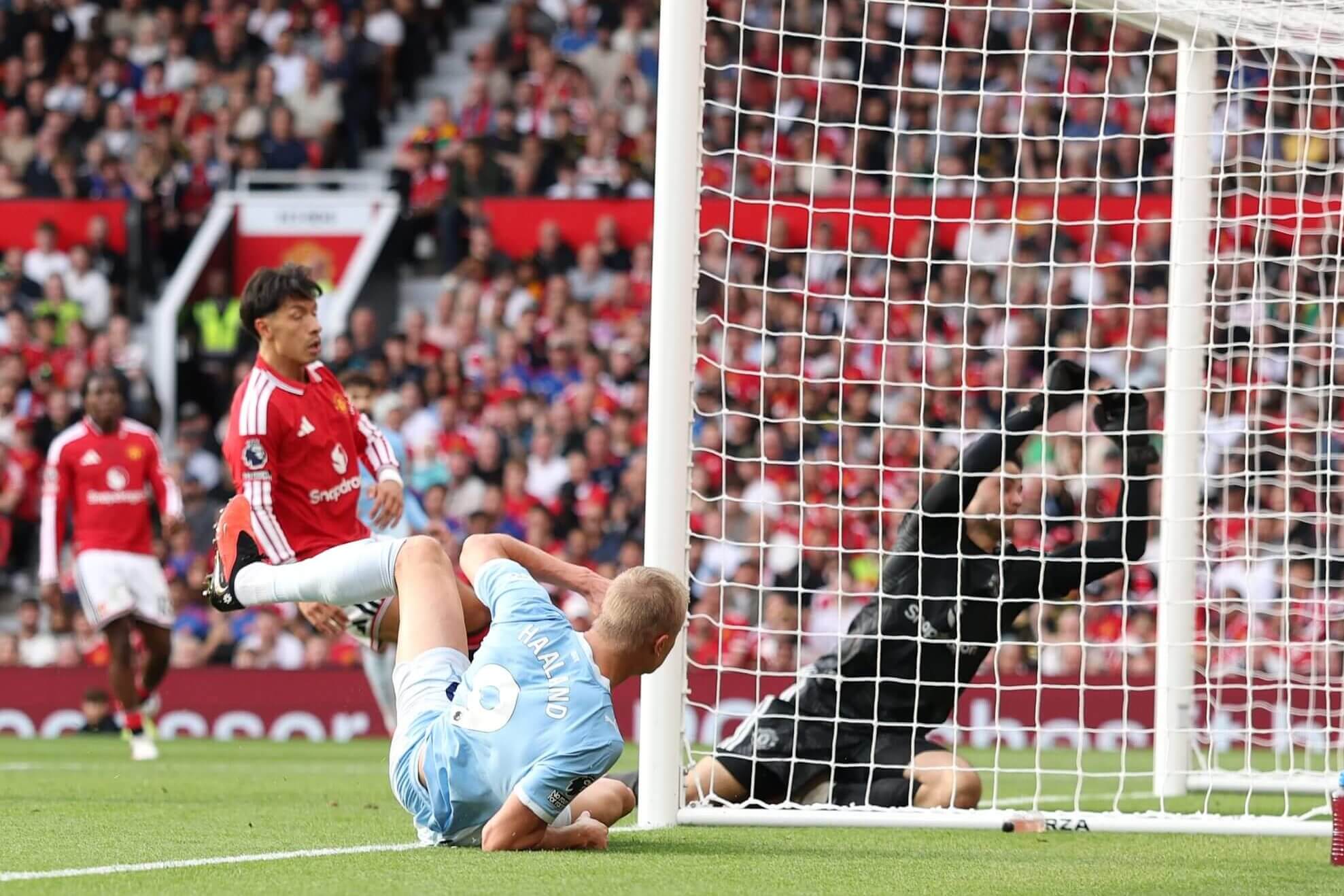 Erling Haaland bundles the ball home against Manchester United