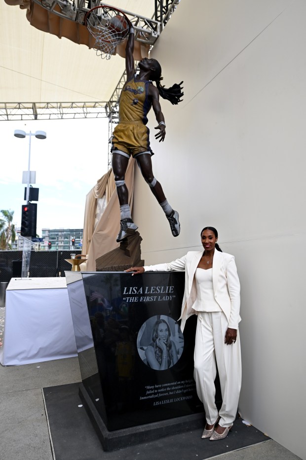 LOS ANGELES, CALIFORNIA - SEPTEMBER 20: Hall of Fame basketball player Lisa Leslie poses next to her newly unveiled statue prior to the game between the Los Angeles Sparks and the Portland Fire at Crypto.com Arena on September 20, 2026 in Los Angeles, California. NOTE TO USER: User expressly acknowledges and agrees that, by downloading and/or using this Photograph, user is consenting to the terms and conditions of the Getty Images License Agreement. (Photo by Griffin C. Hooper/Getty Images)