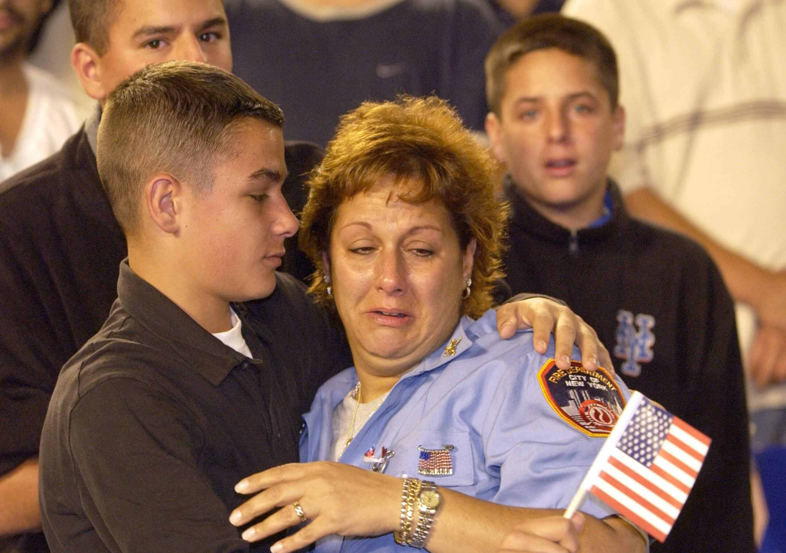 Carol Gies is comforted by her son, Ronnie, before the Mets game against the Atlanta Braves at Shea Stadium in Flushing, New York . Carol lost her husband, who was a New York City Firefighter in the World Trade Center Tragedy.