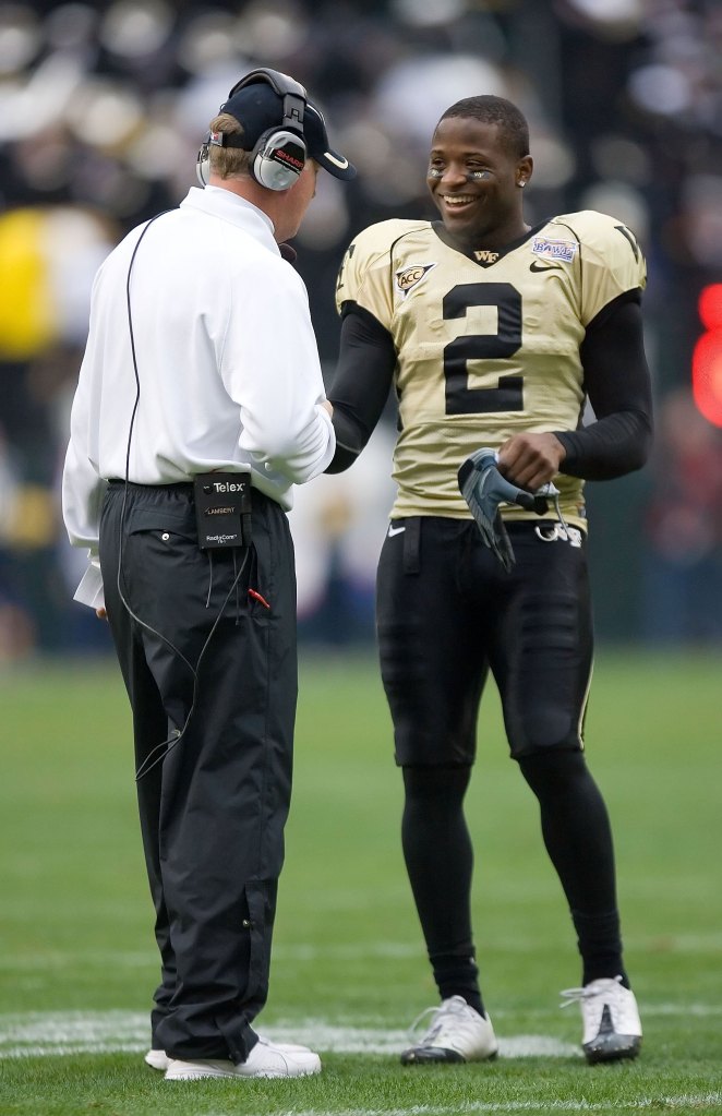 Navy's coach shaking hands with Wake Forest's football player, Riley Skinner, at the EagleBank Bowl.
