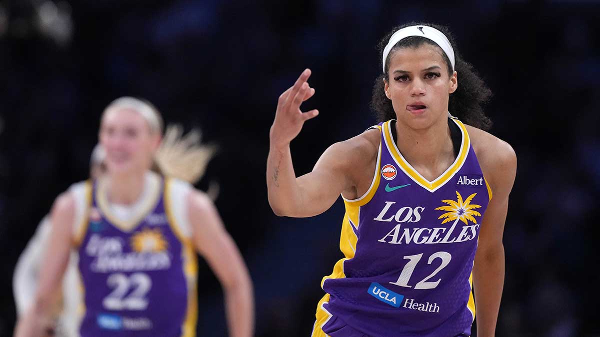 Los Angeles Sparks guard Rae Burrell (12) drives to the basket against Connecticut Sun forward Diamond Miller (1) during the first quarter at Crypto.com Arena.