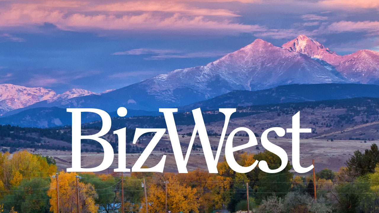 A white version of the BizWest logo, superimposed atop a beautiful photo of Longs Peak and Mount Meeker.