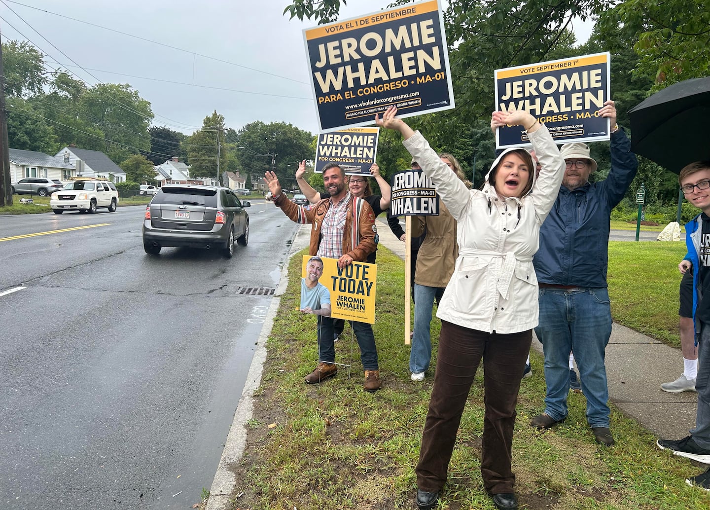 Jeromie Whalen (left) a Democratic candidate in the First Congressional District, joins supporters to greet primary voters at a Springfield polling place on Tuesday.