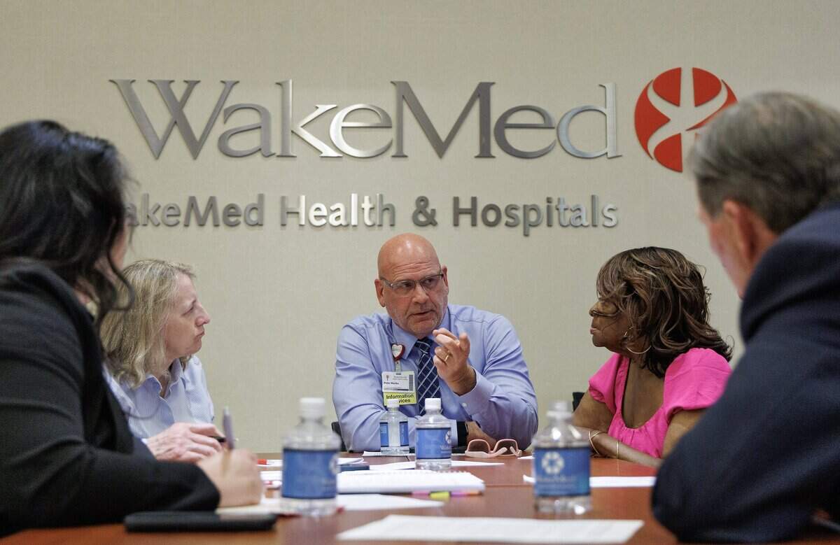 People participate in a group discussion during a community forum held on Tuesday, May 19, 2026, in Raleigh, N.C. about the proposed WakeMed and Atrium merger.