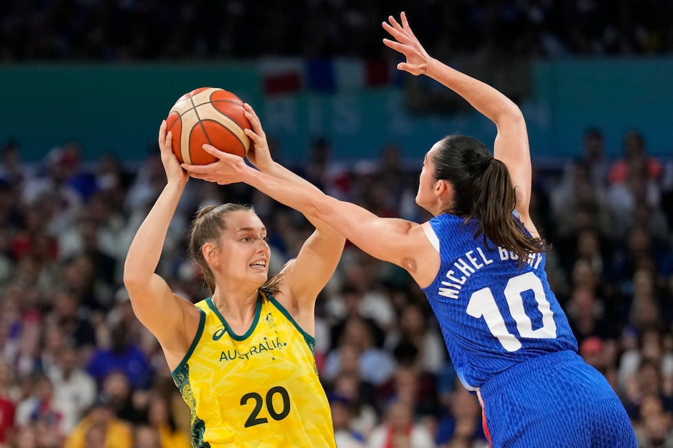 Isobel Borlase (20), of Australia, makes a pass over Sarah Michel Boury (10), of France, in a...
