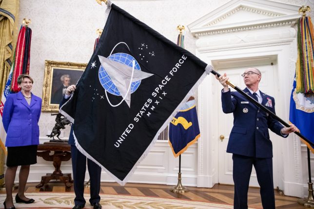 WASHINGTON, DC - MAY 15: Chief Master Sgt. Roger Towberman (R), Space Force and Command Senior Enlisted Leader and CMSgt Roger Towberman (L), with Secretary of the Air Force Barbara Barrett present US President Donald Trump with the official flag of the United States Space Force in the Oval Office of the White House in Washington, DC on May 15, 2020. (Photo by Samuel Corum-Pool/Getty Images)