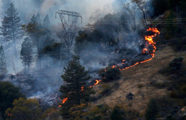 Fires burn near PG&E transmission towers in Butte County in November 2018. (Karl Mondon/Bay Area News Group)