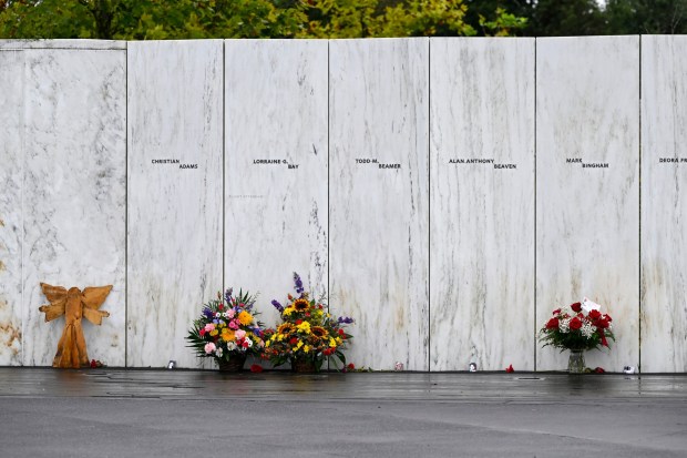 Flowers and other items lay at the Flight 93 National Memorial Wall of Names following a ceremony commemorating the 21st anniversary of the Sept. 11, 2001 terrorist attacks in Shanksville, Pa., Sunday, Sept. 11, 2022. (AP Photo/Barry Reeger)