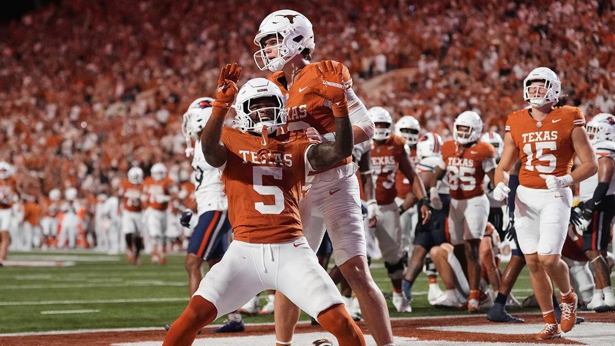 Derrek Cooper and Arch Manning celebrating after a touchdown