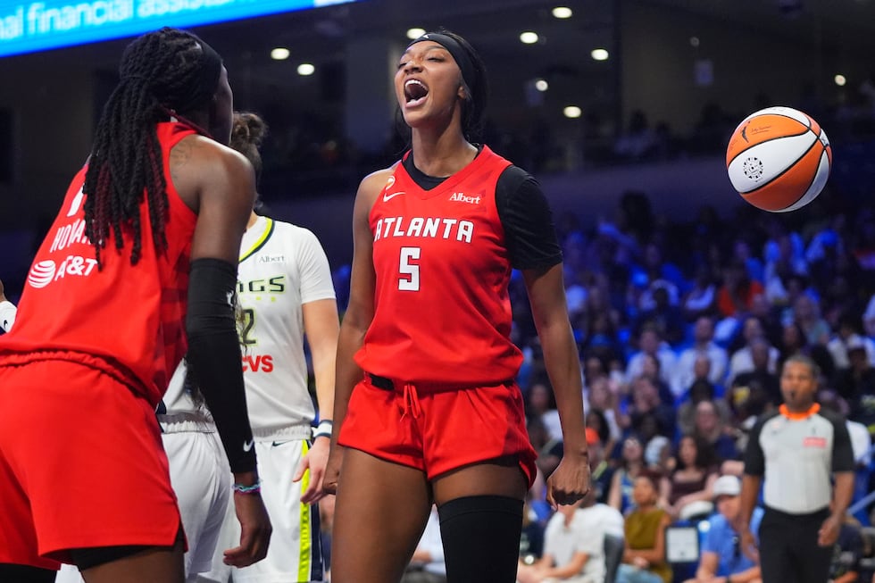 Atlanta Dream forward Angel Reese (5) reacts to scoring with teammate Rhyne Howard (10) during...