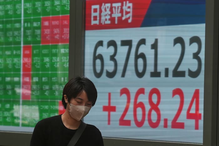 Global shares trade mostly lower after AI stocks sink on Wall Street
