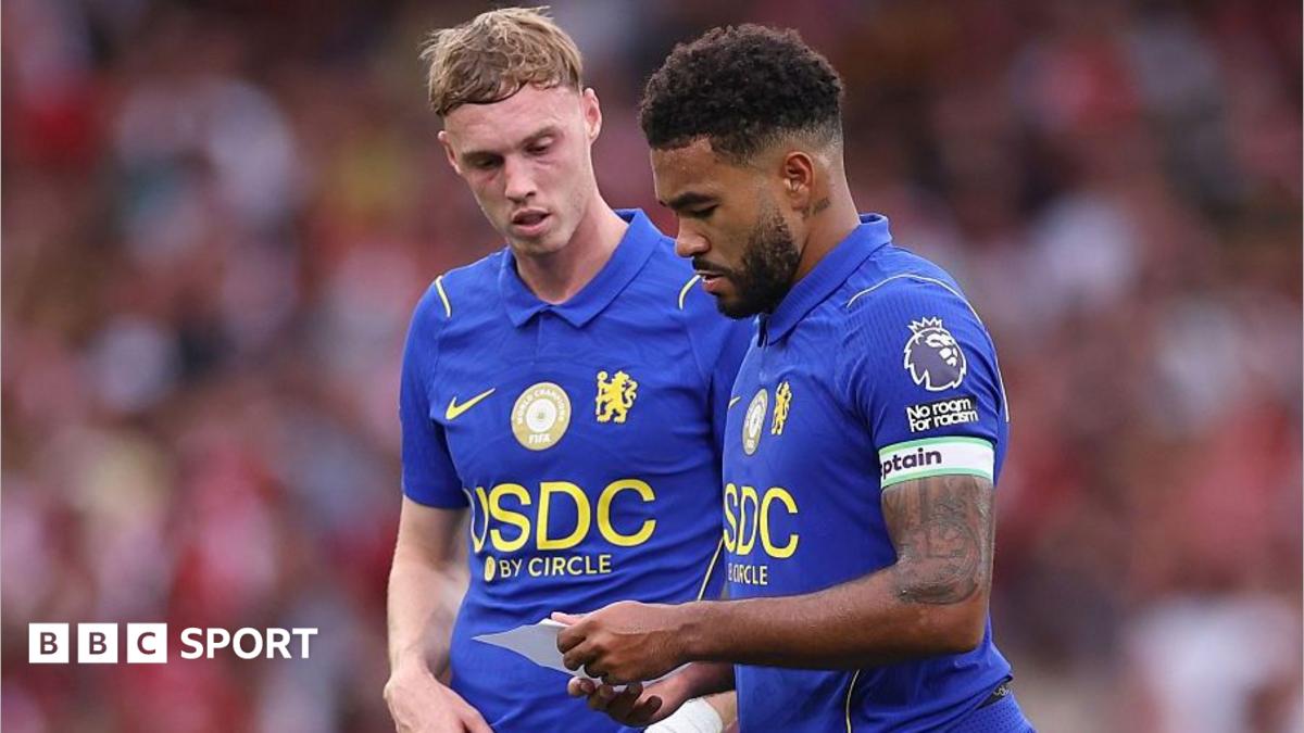 Reece James and Cole Palmer reading a note in the second half against Arsenal
