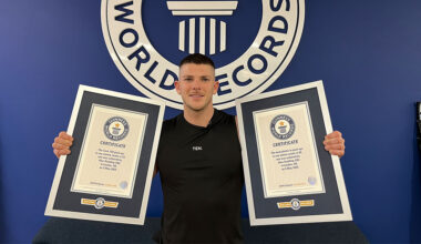 Alex holding two Guinness World Records certificates